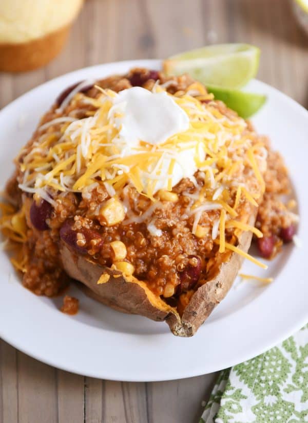 Sweet potato topped with Instant Pot quinoa red bean chili, sour cream and cheese.