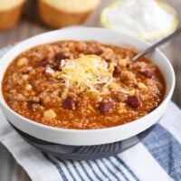 Stone bowl of instant pot quinoa red bean chili with cheese.