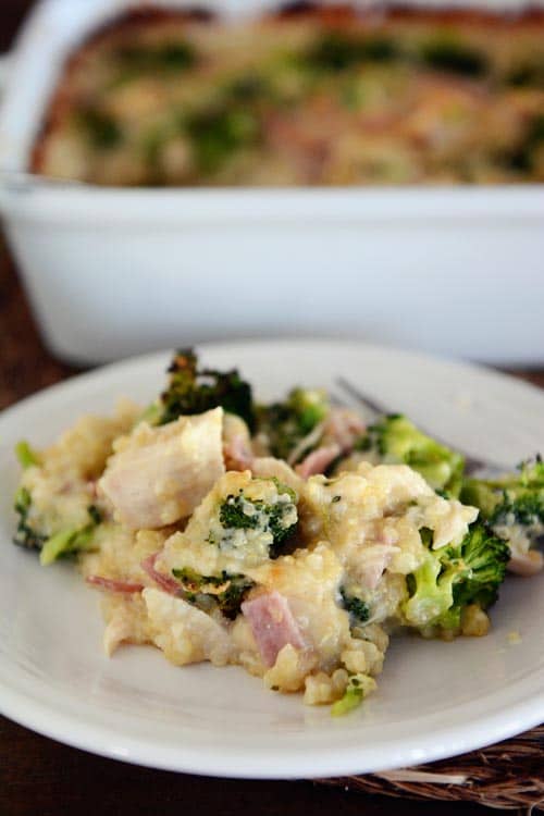 A big helping of cheesy chicken quinoa cordon bleu casserole on a white plate. 