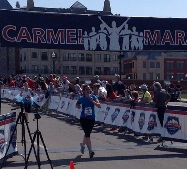 A woman crossing the finish line at a race.