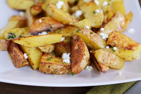 A white platter or golden brown roasted potato wedges.