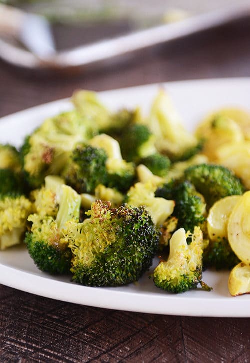 A plate of roasted broccoli and squash.