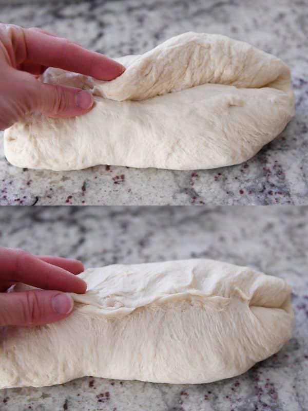 Raw bread dough getting rolled into a loaf.