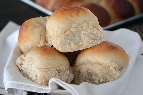 A bunch of baked rolls on a white napkin. 
