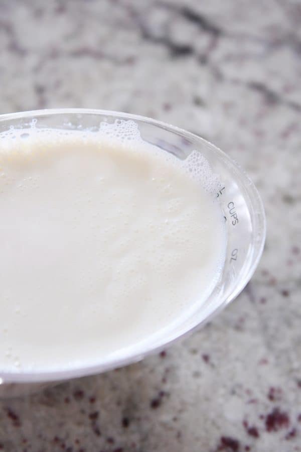 Liquid measuring cup with scalded milk.