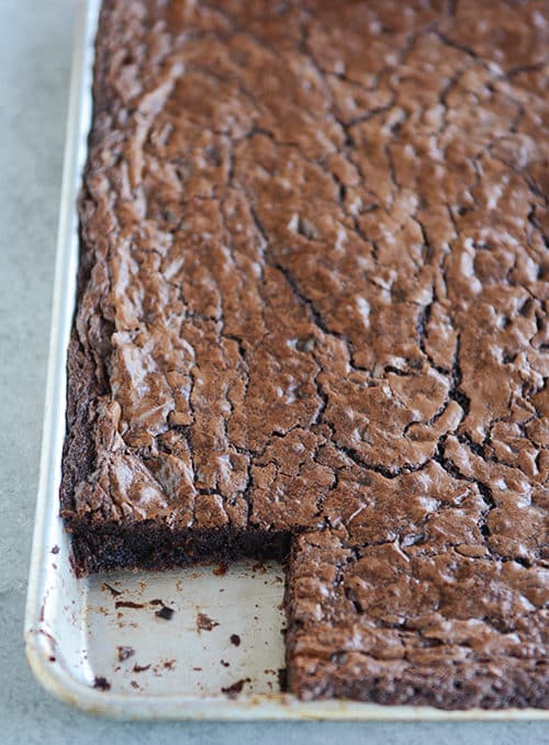 A cookie sheet of brownies with one square cut out.