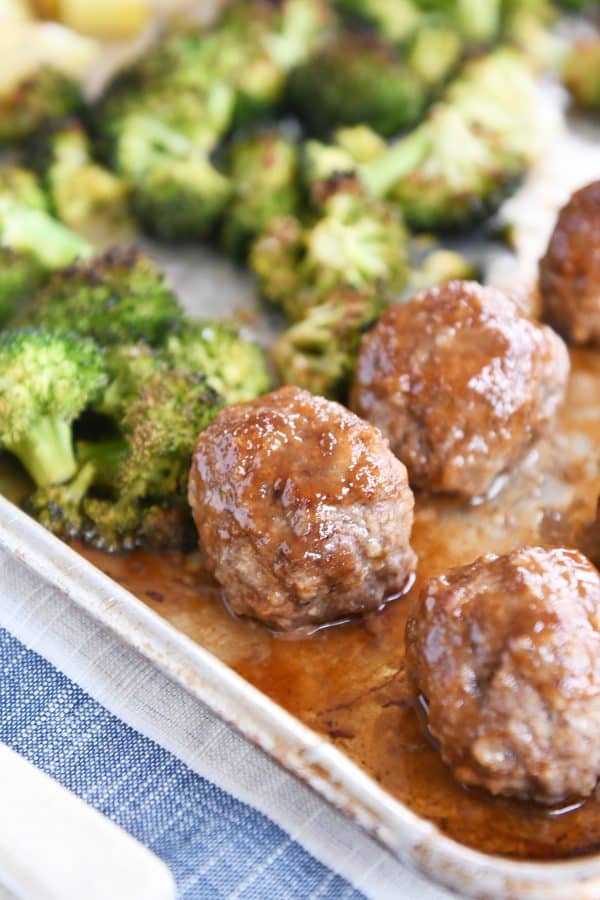 Sweet and sour sheet pan meatballs on sheet pan after being cooked.