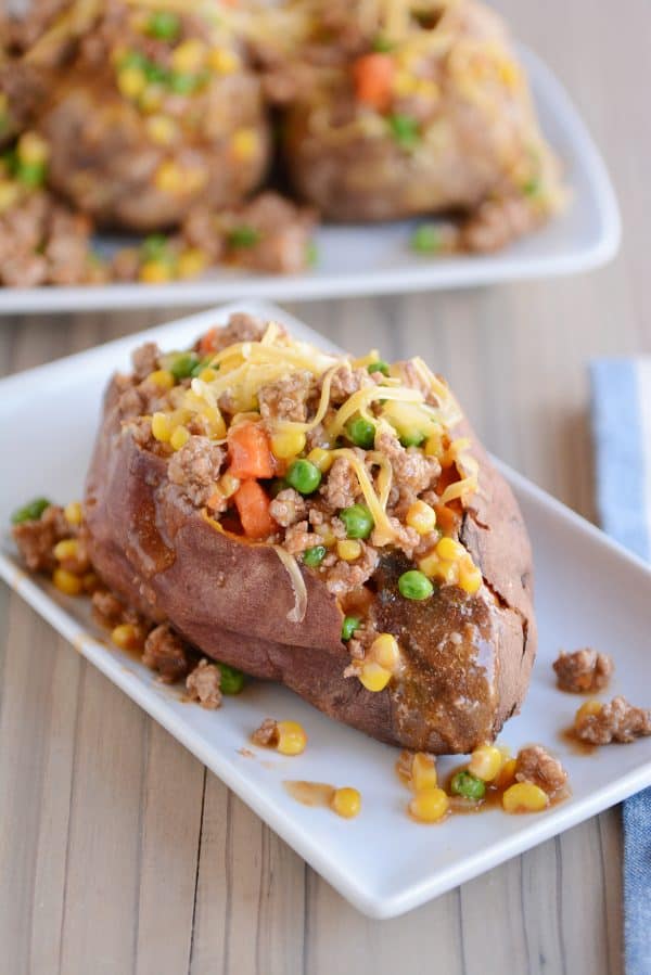 A tray of sweet potatoes with shepherd's pie filling on top.
