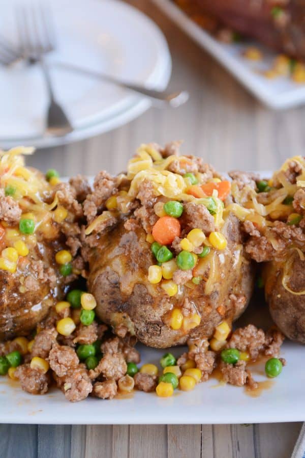 Cooked baked potatoes with shepherd's pie filling on top. 