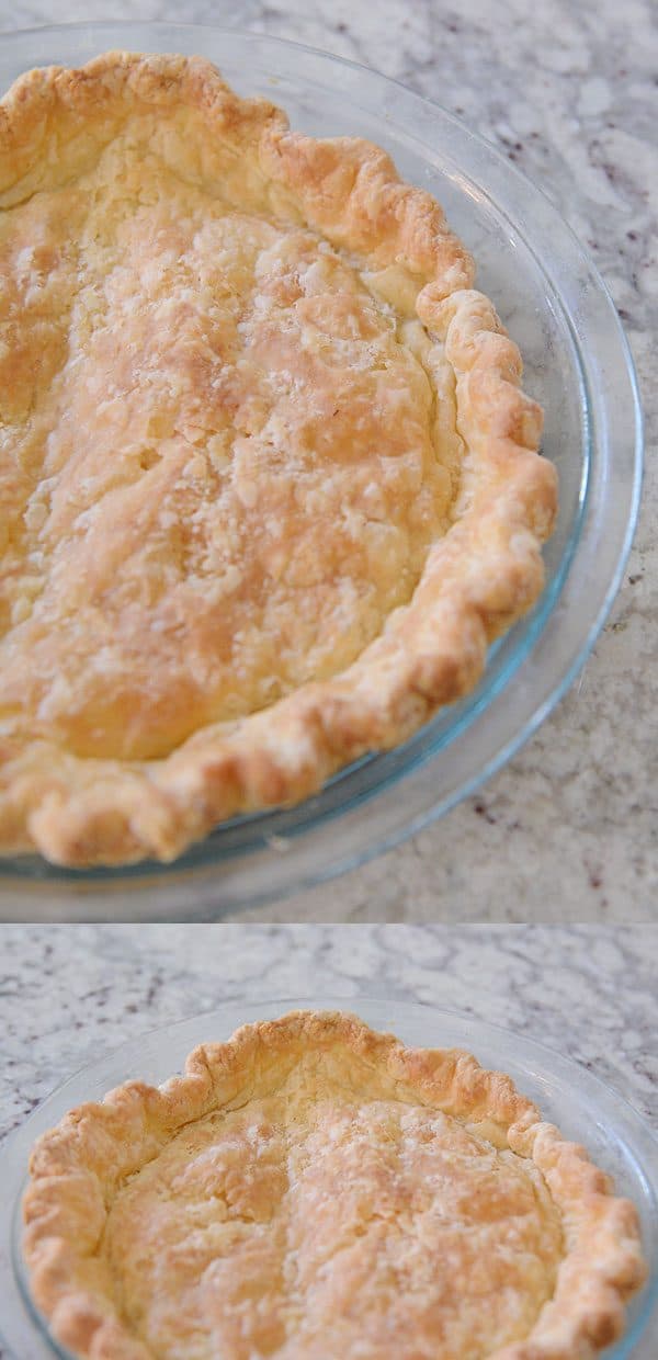 A golden brown cooked pie crust in a glass pie dish.