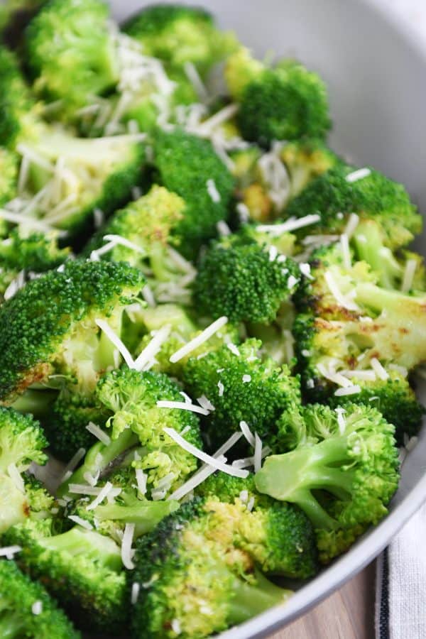 Skillet with broccoli and Parmesan cheese.