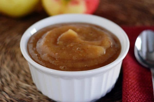 A small white ramekin full of homemade applesauce.