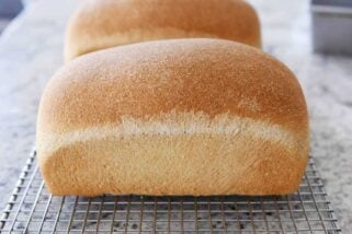 Two loaves of small batch whole wheat bread on cooling rack.