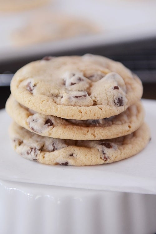Three chocolate chip cookies stacked on top of each other.