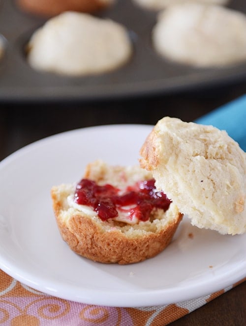 A sour cream muffin split in half with jam and butter in the middle. 