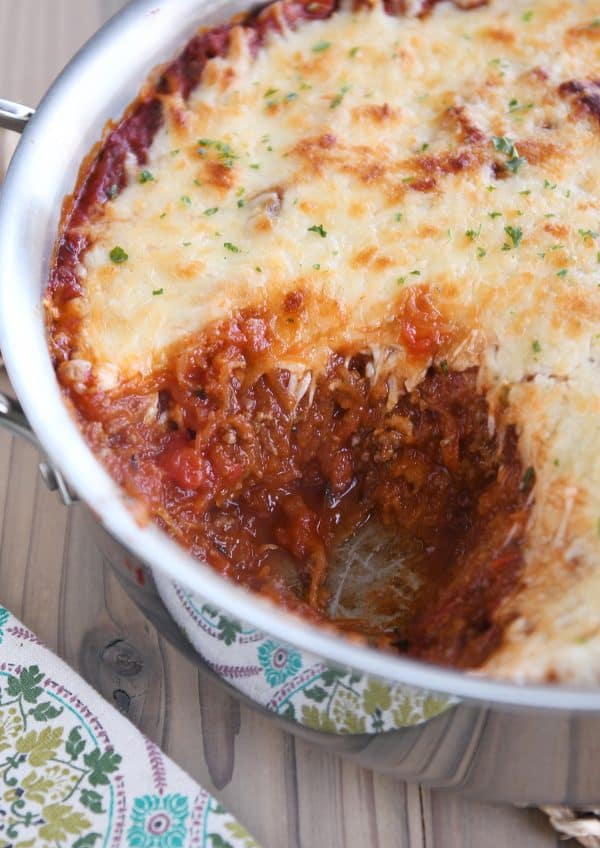 Spaghetti squash spaghetti bake topped with cheese in pan.