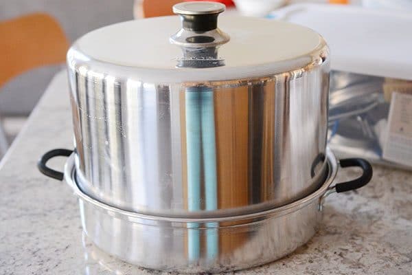 A steam canner on a granite countertop.