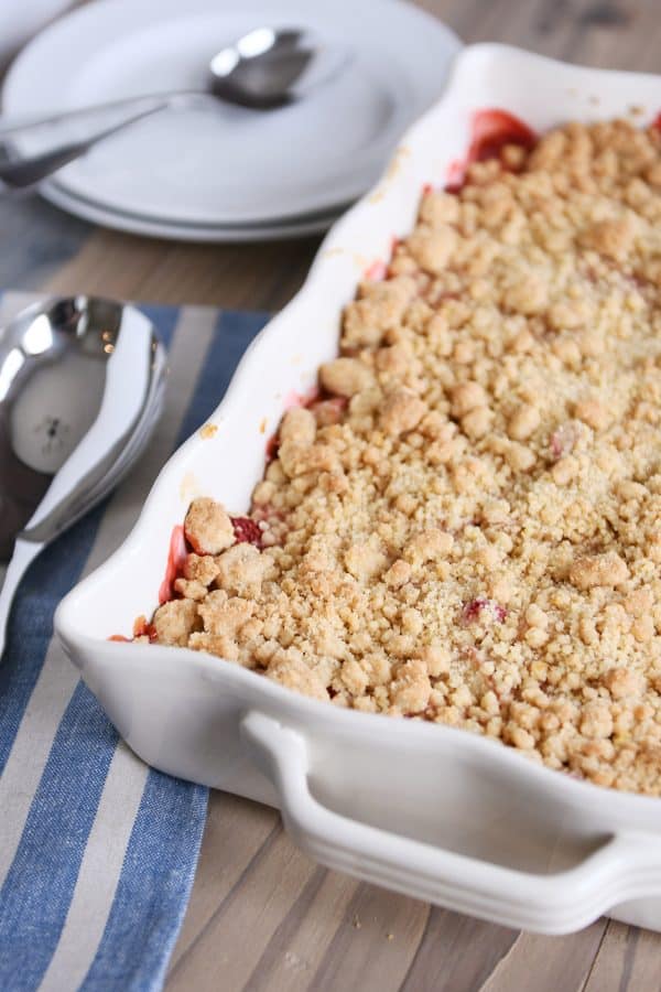 Strawberry rhubarb crumble topping in white baking pan.