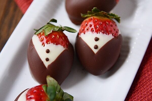 Top view of chocolate dipped strawberries to cook like little tuxedo's.