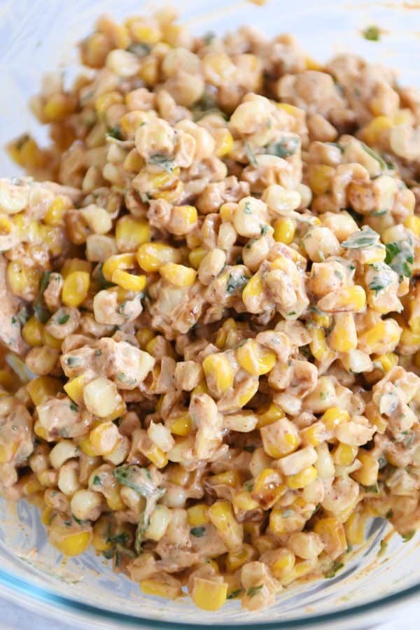 Top down view of Mexican street corn salad in glass bowl.