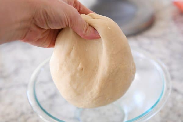Stretching the dough for the perfect small batch cinnamon rolls recipe.