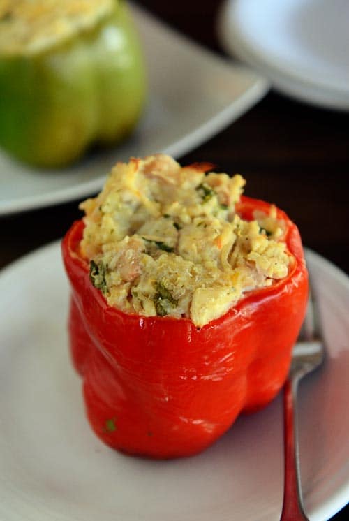 Top view of an echilada stuffed red pepper on a white plate. 