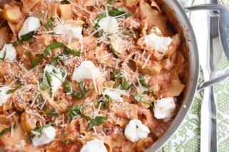 Skillet vegetable lasagna cooked in stainless skillet with dots of ricotta cheese.