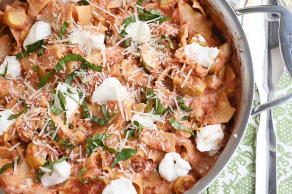 Skillet vegetable lasagna cooked in stainless skillet with dots of ricotta cheese.