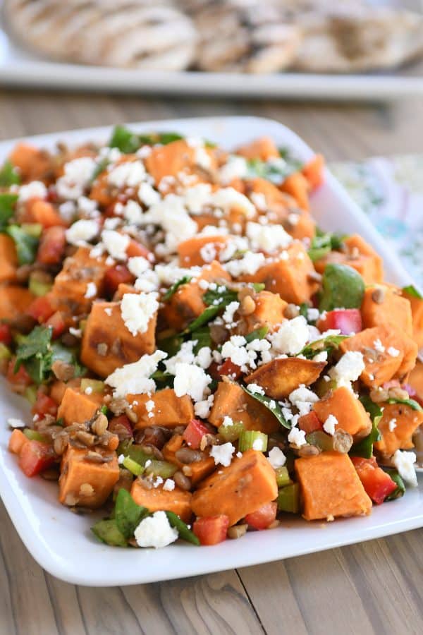 Roasted sweet potato and lentil salad on white platter. 