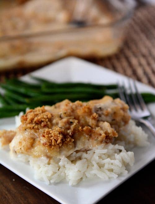 White rice topped with a crunchy-topped swiss cheese chicken breast.