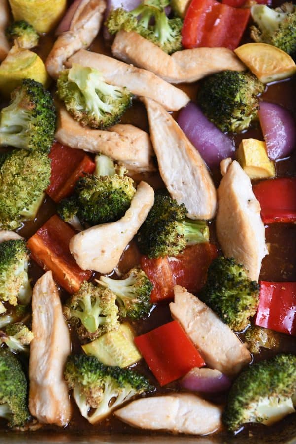 Close up of teriyaki chicken sheet pan dinner with broccoli, peppers and squash.