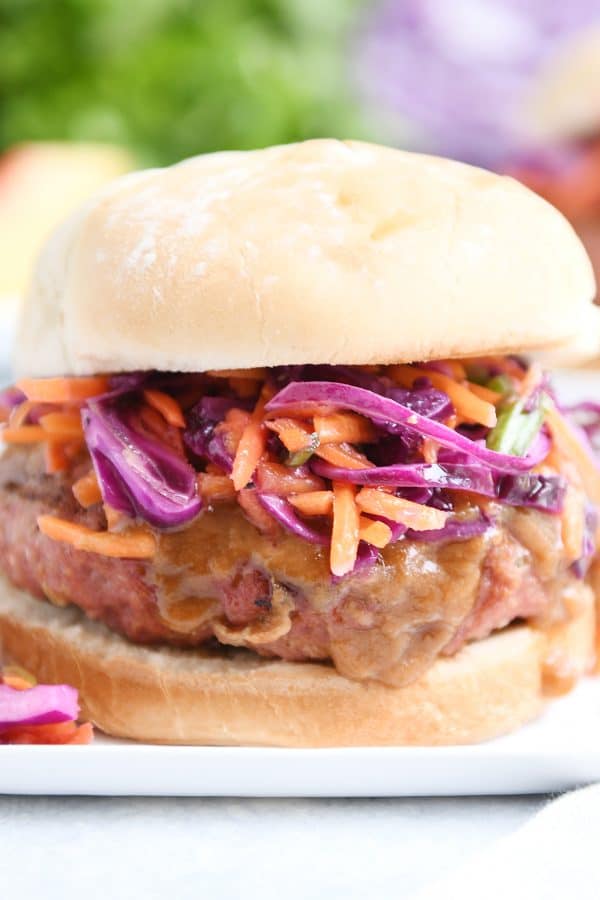 Closeup of Thai burgers on white plate.