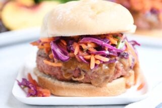 Close up of Thai burgers with peanut sauce and tangy slaw.