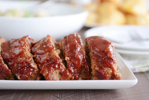 Slices of the best glazed meatloaf on white platter.