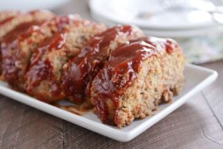 Slices of the best glazed meatloaf on white platter.