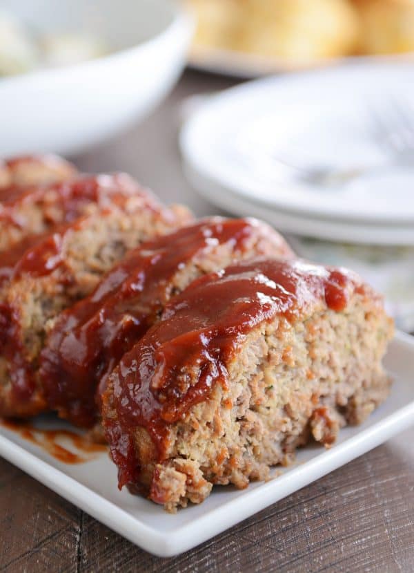 Slices of the best glazed meatloaf on white platter.