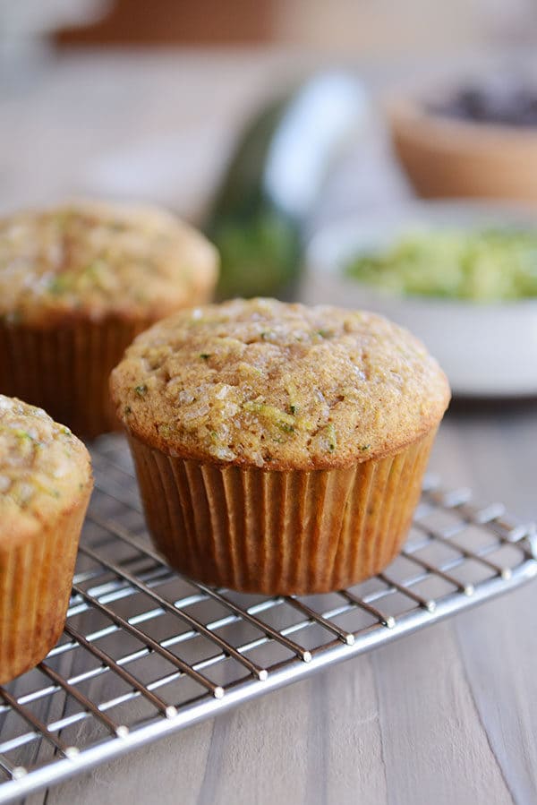 Cooked zucchini muffins on a cooling rack. 