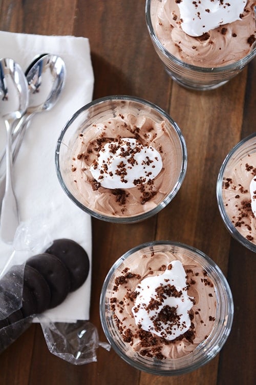 Top view of chocolate cheesecake desserts topped with whipped topping.