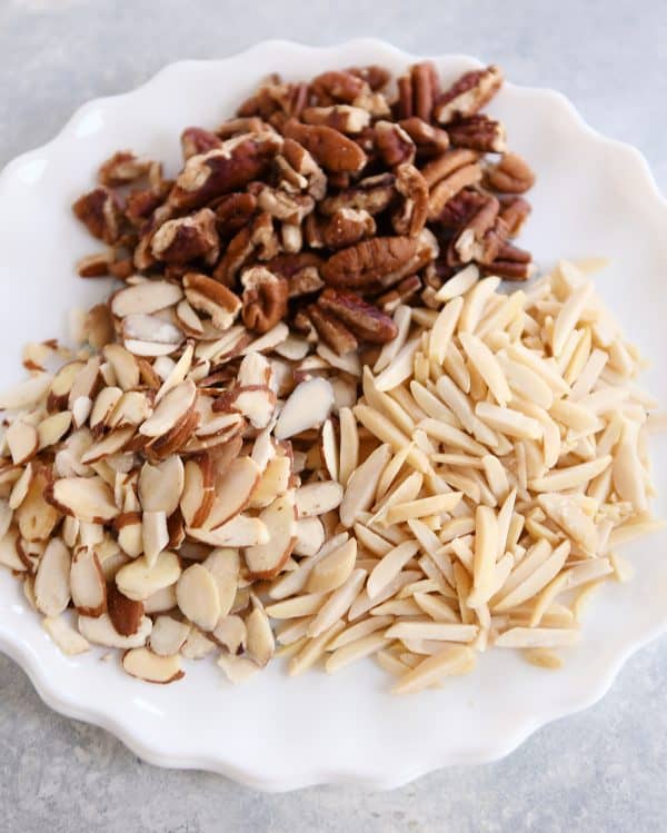 How to toast nuts in the microwave; toasted nuts on white plate.