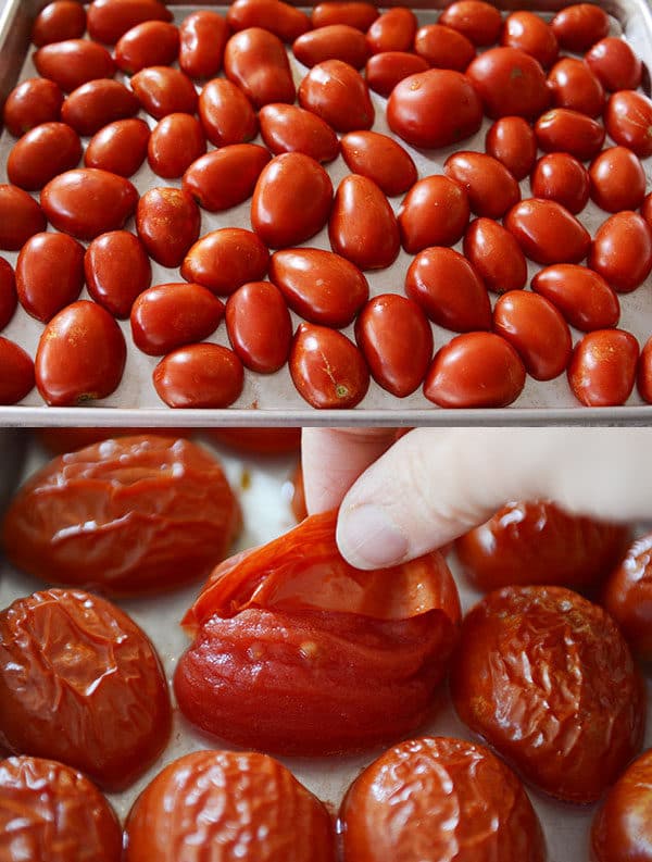 Fresh cherry tomatoes covering a baking sheet pan, and roasted cherry tomatoes on another baking sheet. 