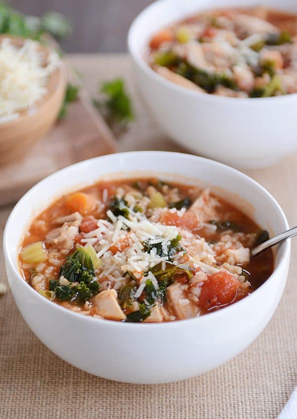 Turkey, vegetable, and brown rice soup topped with parmesan cheese. 