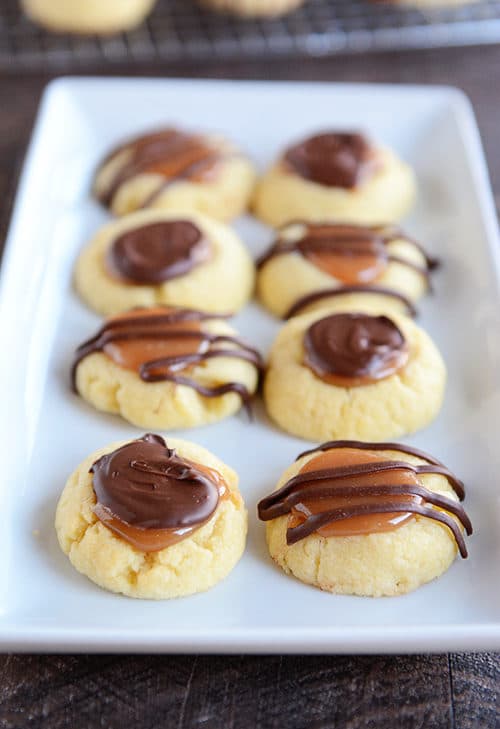 A white platter of caramel and chocolate covered shortbread cookies.