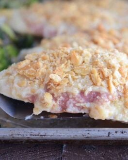 Lift the unstuffed chicken cordon bleu with a spatula.