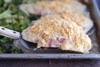 Lifting unstuffed chicken cordon bleu with spatula.