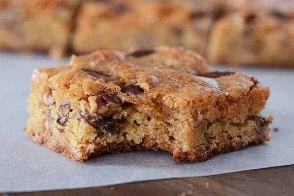 A pecan brownie with a bite taken out.