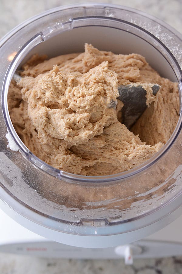 A large batch of cookie dough inside a Bosch mixer.