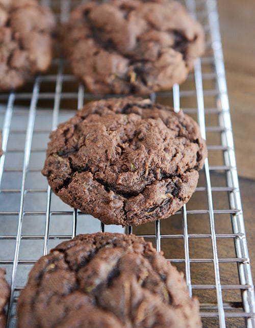 Chocolate zucchini cookies on a cooling rack.