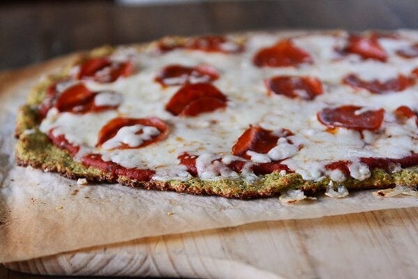 A zucchini crust pepperoni pizza on a piece of parchment.