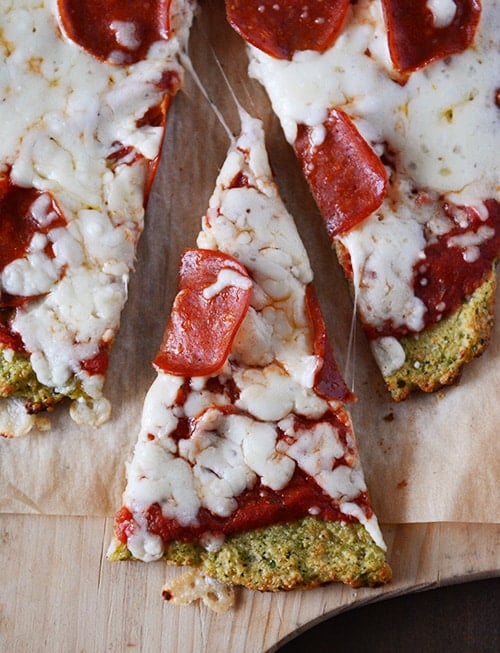 Top view of a zucchini crust pepperoni pizza with a slice cut out.