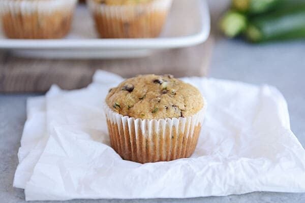 A chocolate chip zucchini muffin sitting on a napkin.